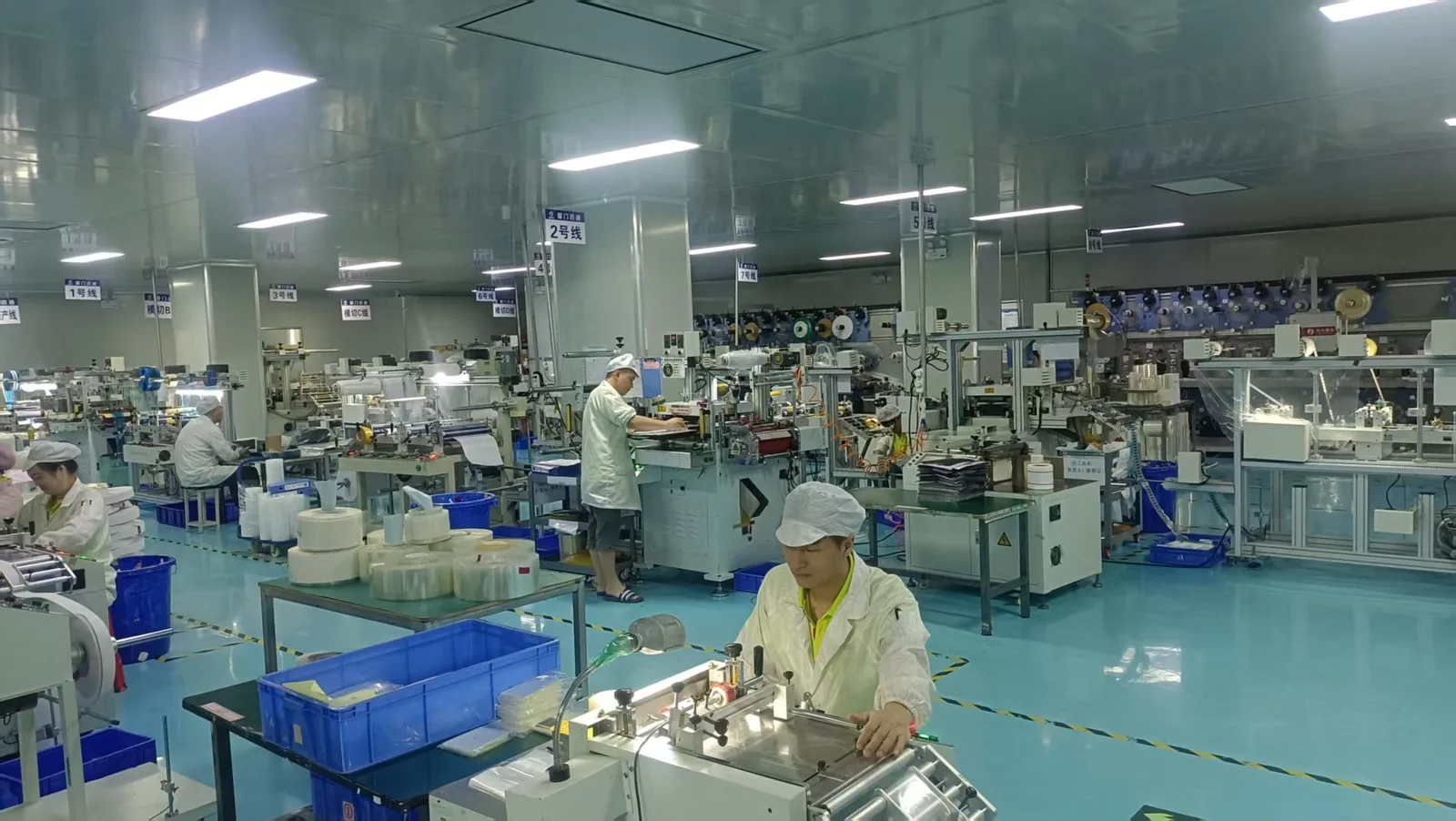 Production team working across multiple die-cutting lines